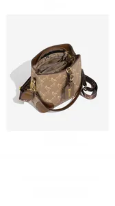 Detailed interior view of a brown bucket bag showing multiple compartments and spacious lining