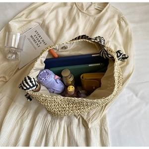 Detailed interior view of a straw tote bag showcasing large capacity with daily essentials