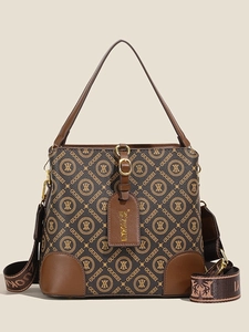 Brown monogram bucket bag with leather trim and wide woven strap on white background