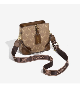 Detailed view of the vintage brown bucket bag with horse pattern and wide fabric strap