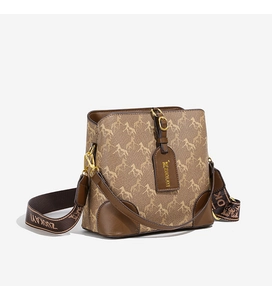 Detail of the brown bucket bag showing the horse print pattern and wide shoulder strap
