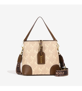 Detail of canvas bucket bag with horse print, leather trim and wide jacquard strap