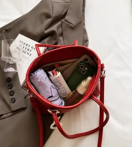 Top-down view of red leather tote bag with a spacious interior for phone and umbrella
