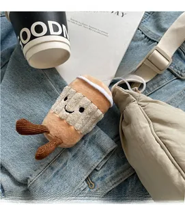 Creative coffee cup plush pendant with smile face hanging on a canvas crossbody bag