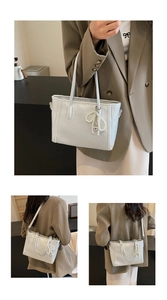 Detail of silver tote bag with lychee texture and decorative pearl bow charm