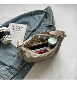 Top view of beige canvas crescent bag showing large storage capacity for daily essentials