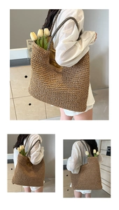 Close-up of large straw tote bag with black and white striped woven handles and tulip decor