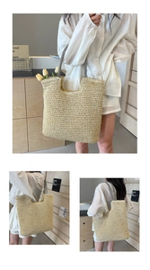 Detail of woven straw tote bag featuring black and white striped handles and a natural texture