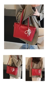 Detail of red tote bag with pearl bow charm and textures on high-quality PU leather