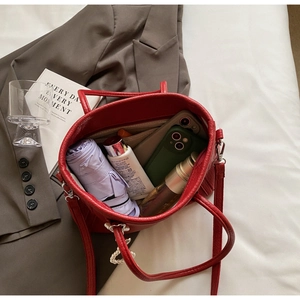 Macro view of large red PU leather tote bag interior showing spacious capacity
