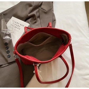 Top view of red lychee grain tote bag with pearl pendant and interior zipper pocket