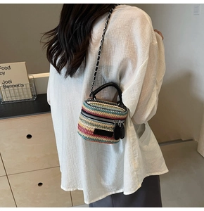 Detail of colorful striped woven mini bag with metal chain strap and top handle