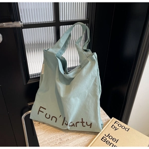 Détail du sac cabas en toile bleu clair avec imprimé Fun'party marron sur marbre