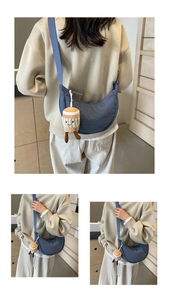 Sac bandoulière bleu en nylon avec charmant pendentif café dans un décor moderne