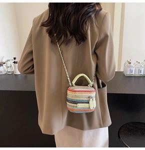 Mini multi-color woven straw bag with green leather handle and silver chain strap details