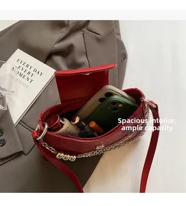 Detail showing the large interior capacity of this red crocodile pattern chain bag