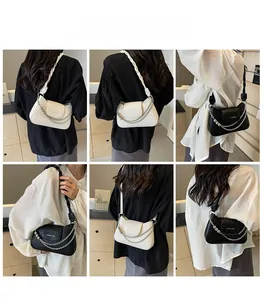 Crocodile pattern underarm bags in black and white shown in various shoulder carry styles