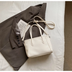 Top view of cream white tote bag with lychee texture and adjustable shoulder strap