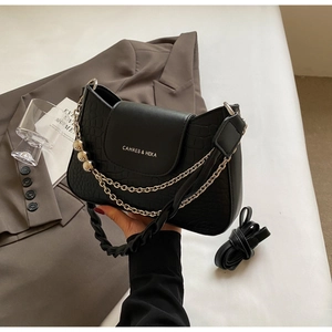 Detail of black crocodile pattern PU leather bag with chain and brand logo