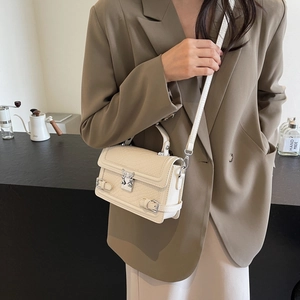 Chic beige crocodile embossed square crossbody bag with a unique silver bird-shaped buckle