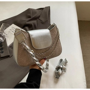Detail of khaki crocodile texture bag with silver metallic flap and luxury chain