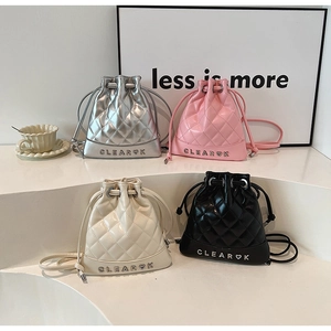 Quilted drawstring bucket bags in four colors with a signature metallic heart logo detail