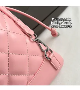 Detail view of pink quilted leather bag featuring a silver detachable swivel ring hook