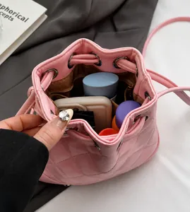 Top view of pink quilted bucket backpack showing spacious interior with personal items