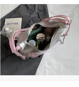 Top view of spacious metallic silver tote interior with daily essentials and pink straps