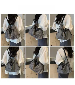 Detailed model views of grey canvas drawstring backpack with red heart and star patterns