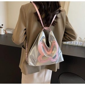 Silver metallic tote bag with pink butterfly patches and adjustable shoulder straps