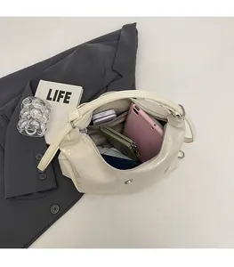 Detail view of spacious cream tote bag interior holding phone and wallet essentials