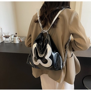Rear view of a chic black and silver tote backpack with metallic chain and gloss finish