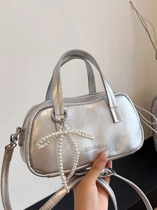 Silver metallic mini tote bag with pearl bow charm and elegant wrinkled leather texture