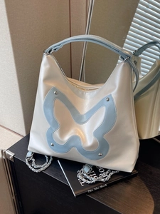 Chic cream and blue tote bag featuring butterfly patch and silver chain detail