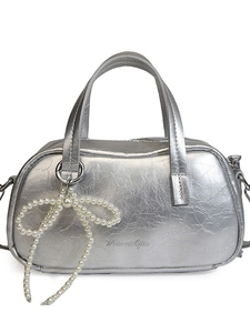 Futuristic silver metallic handbag with crinkled texture and pearl bow charm accessory