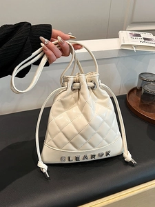 Chic quilted beige bucket backpack with diamond stitching and diamond-set heart metal logo