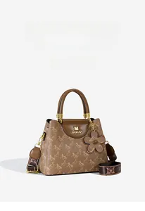 Close-up of brown patterned bucket bag with wide strap and gold M logo detail
