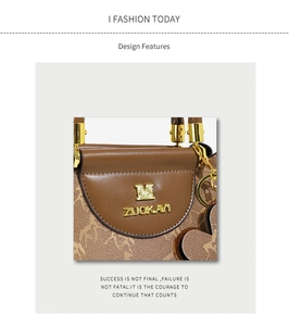 Close-up of vintage brown leather handbag with gold M logo and heart charm detail
