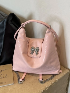 Pink glossy leather tote backpack with silver bow and metal chain strap for women