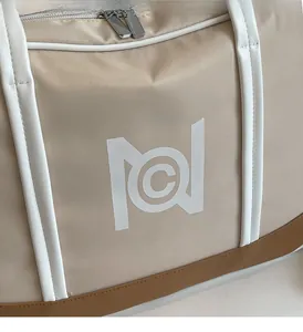 Detail of light beige nylon tote bag with dual metal zippers and white trim details