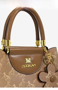 Detail of brown bucket bag featuring horse pattern print and golden logo hardware