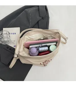 Macro view of beige tote bag interior capacity with tablet, umbrella, and daily essentials