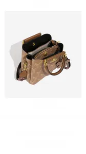 Detailed interior of brown tote bag showing multi-compartment layout and zipper pocket