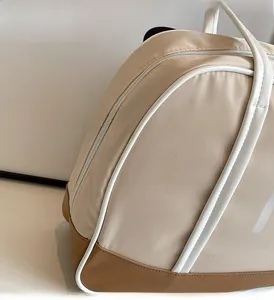 Detail of a vintage tote bag with contrast piping and a dual zipper on nylon fabric