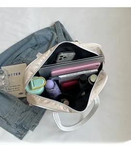 Top view of spacious interior of a beige tote bag holding a laptop and essentials