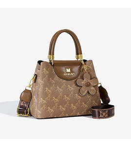 Close-up of brown bucket bag featuring horse pattern print and wide logo fabric strap