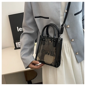Detail of transparent black PVC jelly bag with OWU logo and adjustable crossbody strap