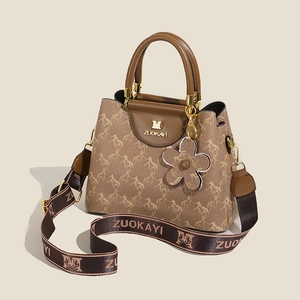 Fashionable brown bucket bag for women featuring horse print and stylish wide strap