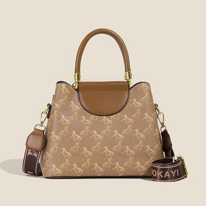 Chic brown bucket bag with horse print fabric and wide jacquard shoulder strap